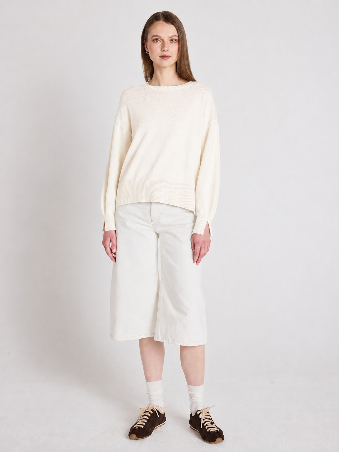 Cream cashmere knit worn with long shorts
