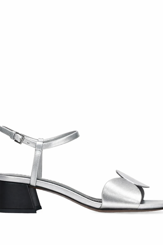 Silver sandal with a black heel on a white background