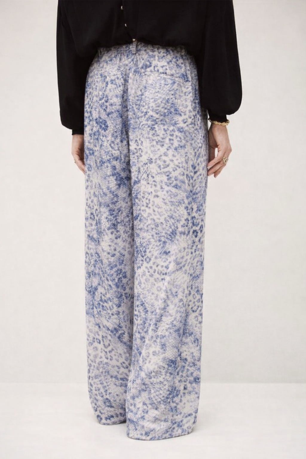 Rear view of silky blue animal print straight wide leg trousers from ba&sh
