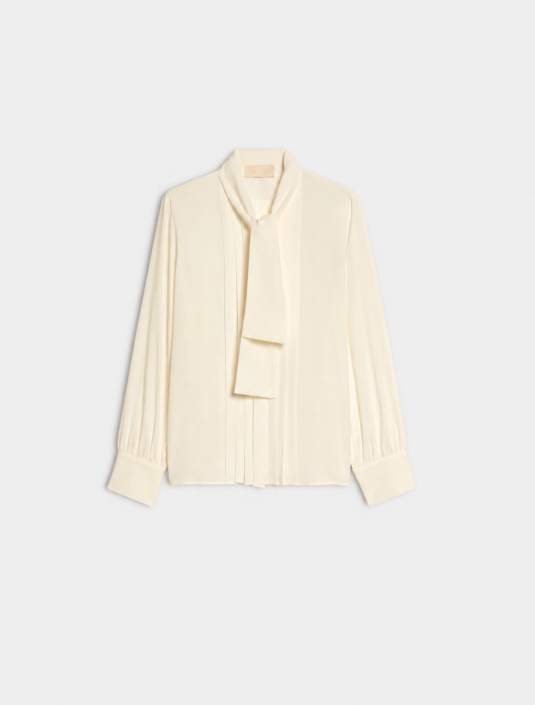 A cream long-sleeve blouse with a draped tie-neck detail, shown flat against a light gray background.