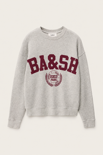 A light gray heather crewneck sweatshirt featuring a maroon'BA&SH' graphic and a circular crest on the front, displayed against a light off-white background.