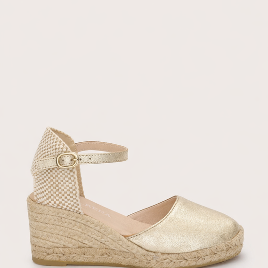 gold espadrille sandal on a white background 