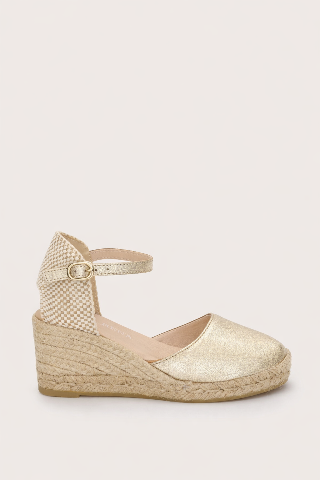 gold espadrille sandal on a white background 