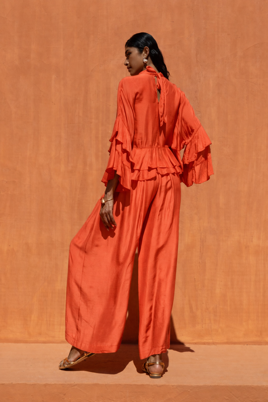 Woman wearing an orange outfit against an orange background