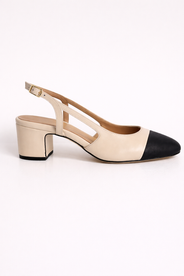 cream heeled shoe with a slingback on a white background.