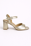 Gold high-heeled sandal on a white background