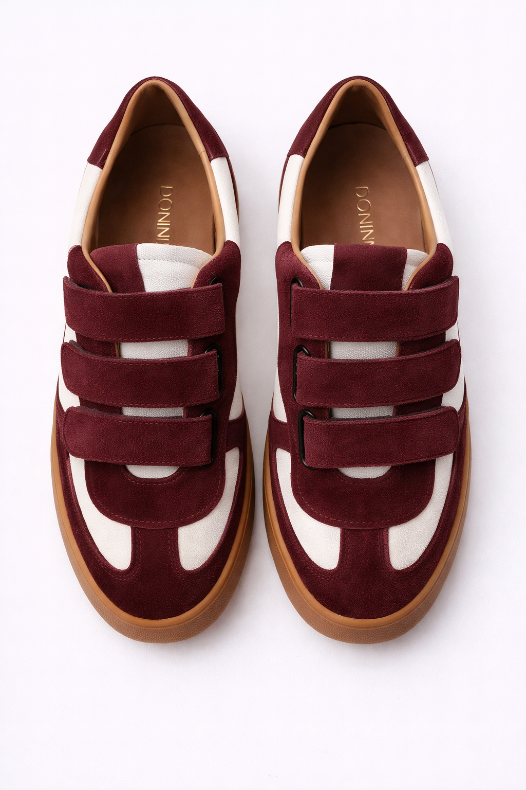 burgundy and white velcro trainer on a white background