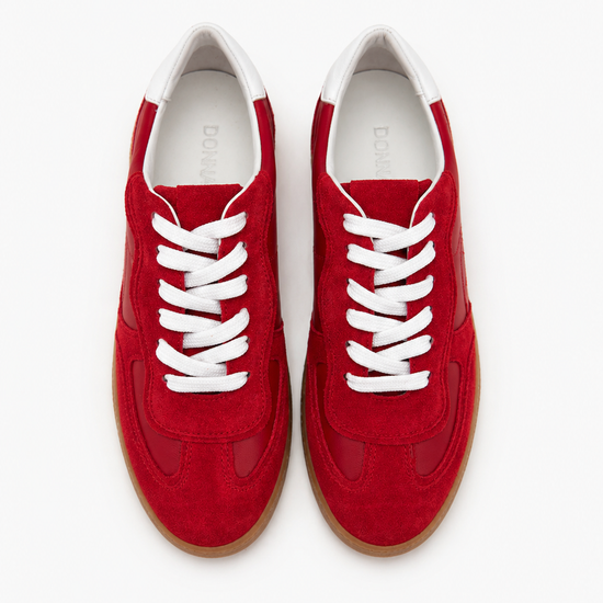 Red sneakers with white laces on a white background