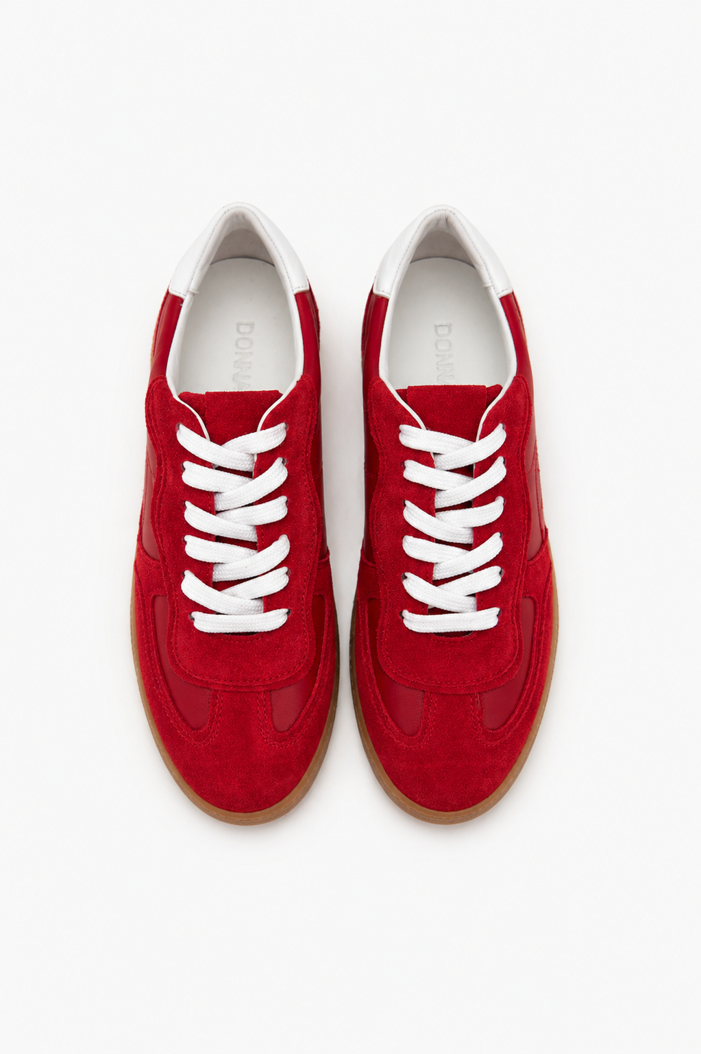 Red sneakers with white laces on a white background