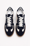 Navy blue sneakers with white laces on a white background