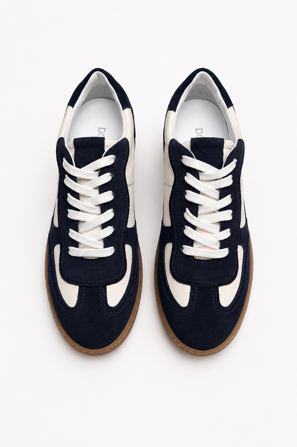 Navy blue sneakers with white laces on a white background
