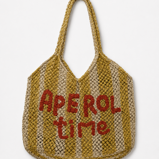 Woven bag with yellow stripes and slogan on a white background.