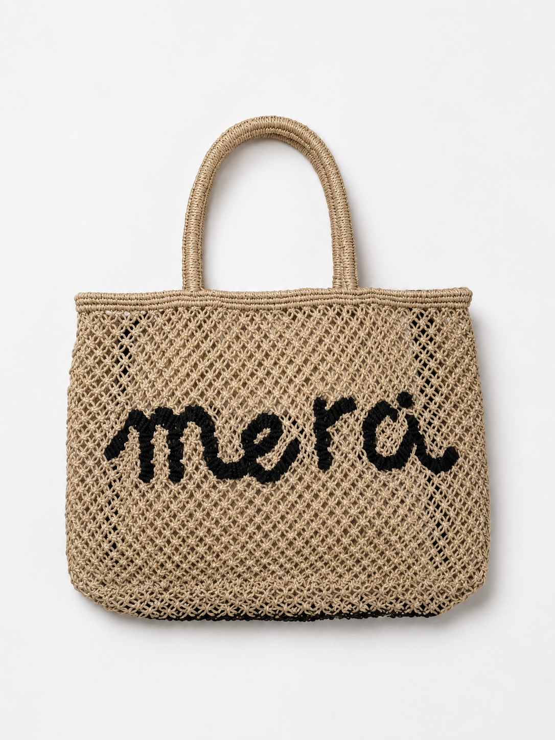 Product shot of woven bag with navy slogan on it on a white background.