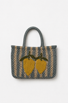 Woven bag with lemon design on a white background