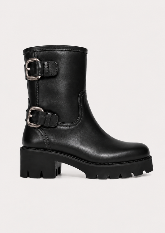 A black leather mid-calf boot with two buckle straps and a chunky lug sole, shown against a plain light background.