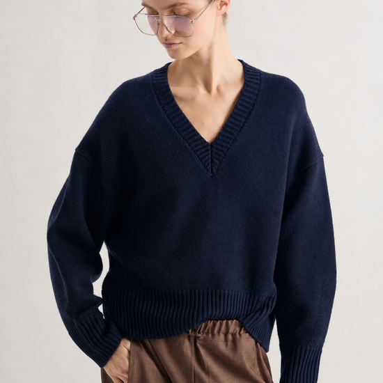 Chunky V neck jumper in navy worn with brown trousers