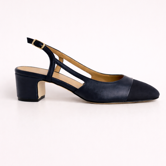 Navy blue shoe with a slingback on a white background
