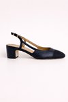 Navy blue shoe with a slingback on a white background