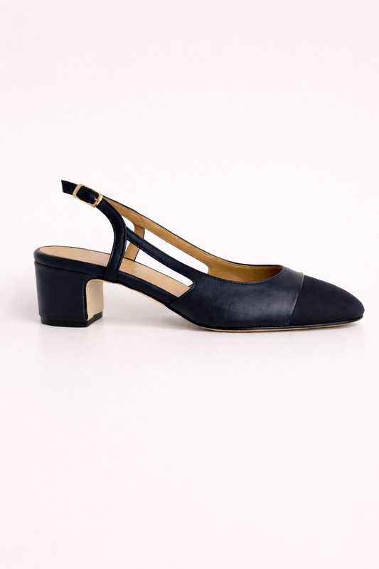 Navy blue shoe with a slingback on a white background