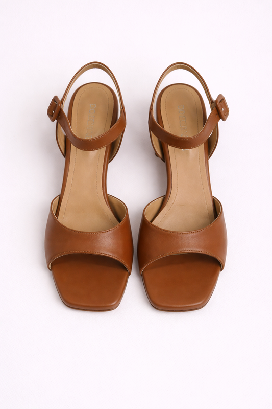 Pair of tan open-toe sandals on a white background