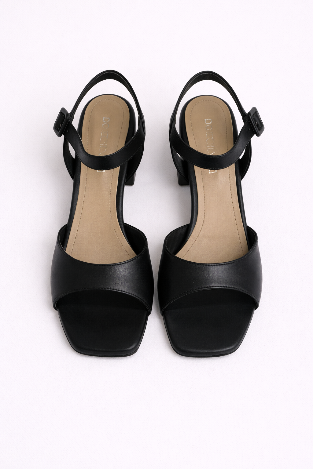 Black high-heeled sandals on a white background