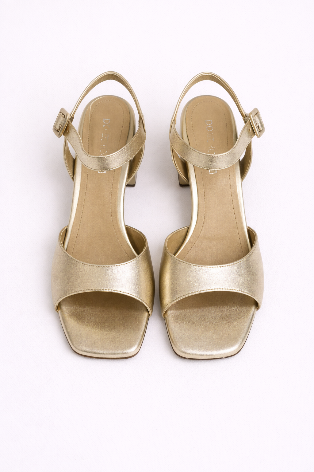 Gold high-heeled sandals on a white background
