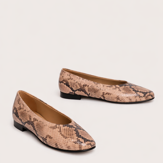 Pair of snake print flats on a light background