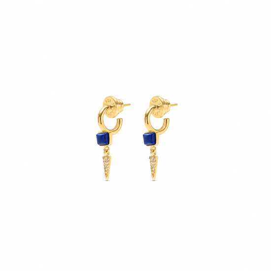 A pair of gold hoop earrings with a small square blue stone and a dangling pointed gold spike embellished with tiny clear stones, shown on a plain white background.