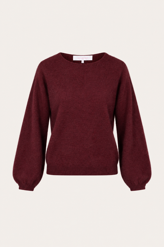 A long-sleeve crewneck sweater in a deep burgundy color, displayed against a solid off-white background.