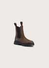 A single brown leather Chelsea-style boot with black elastic side panels and a chunky black sole, photographed on a plain light beige background.