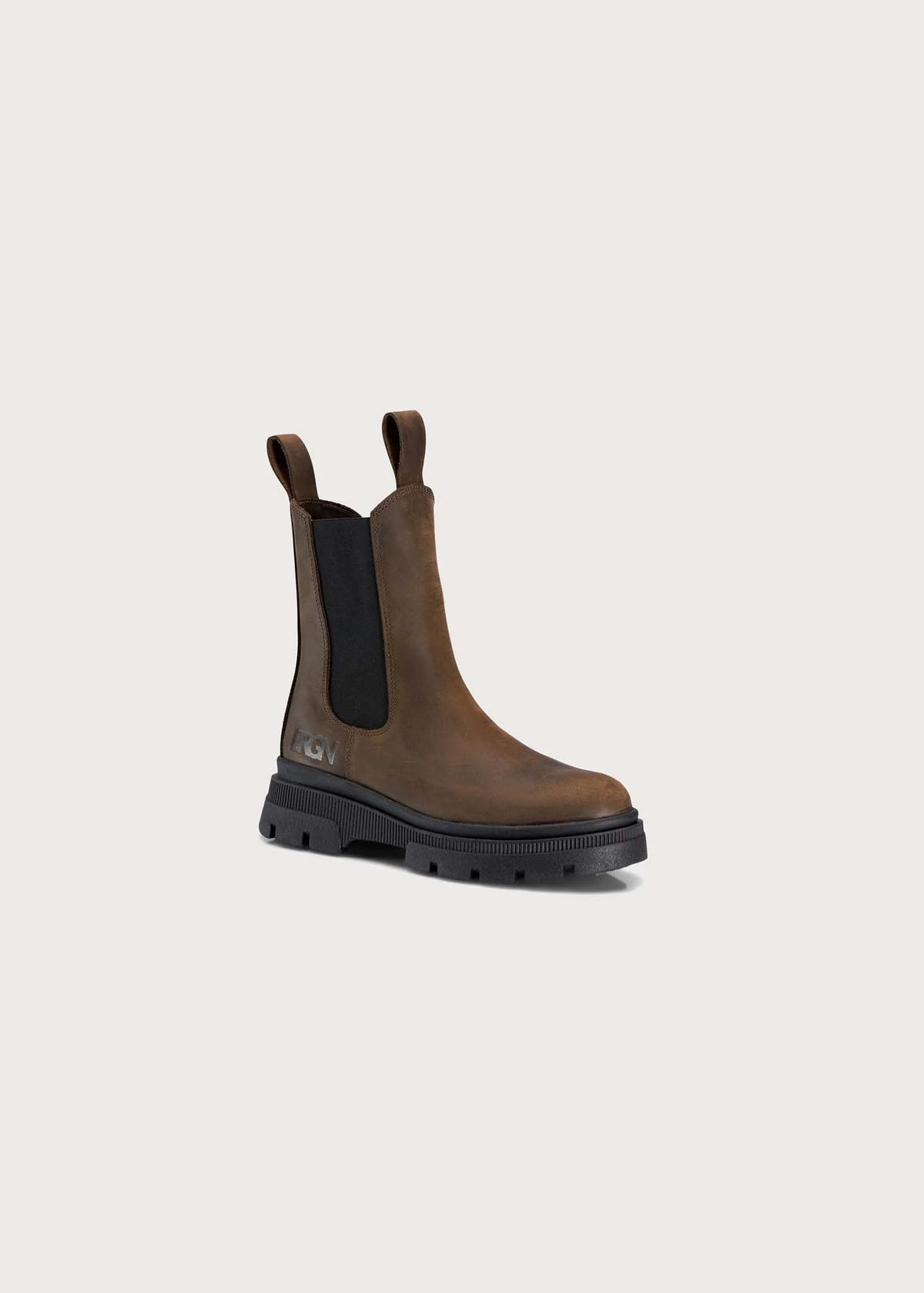 A single brown leather Chelsea-style boot with black elastic side panels and a chunky black sole, photographed on a plain light beige background.