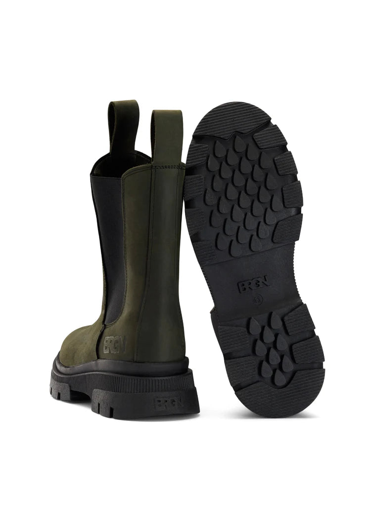 green waterproof chelsea boot with black rubber sole and pull on tabs under view