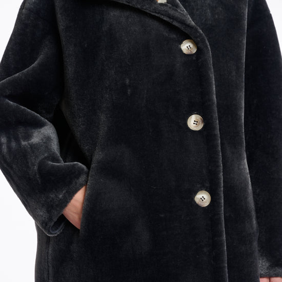 dark grey faux fur long line coat with stand neck and 3 button closure from rino and pelle close up
