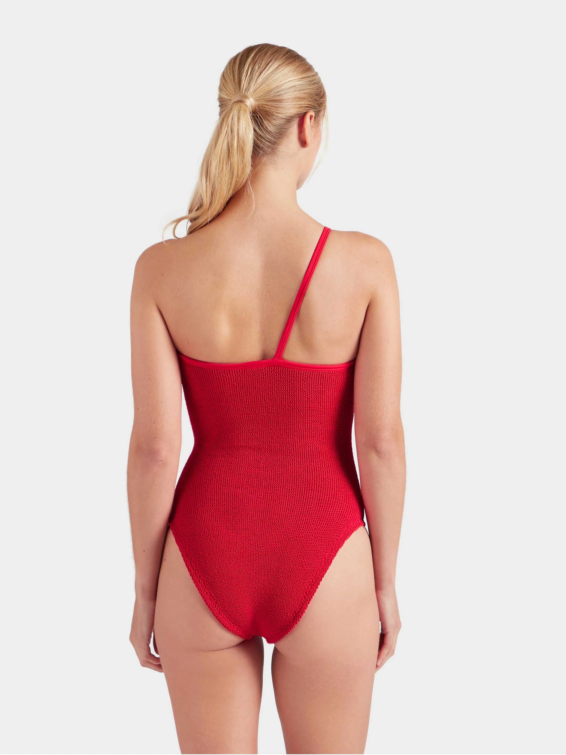 Red swimsuit worn by a model on a white background from Hunza G