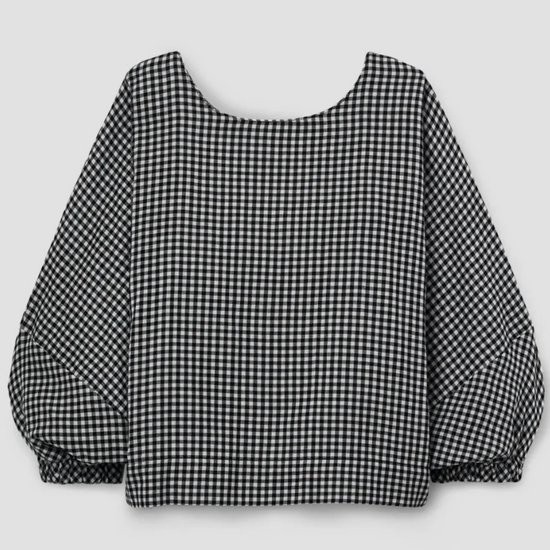 Black and white checkered blouse with balloon sleeves on a light gray background