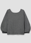 Black and white checkered blouse with balloon sleeves on a light gray background
