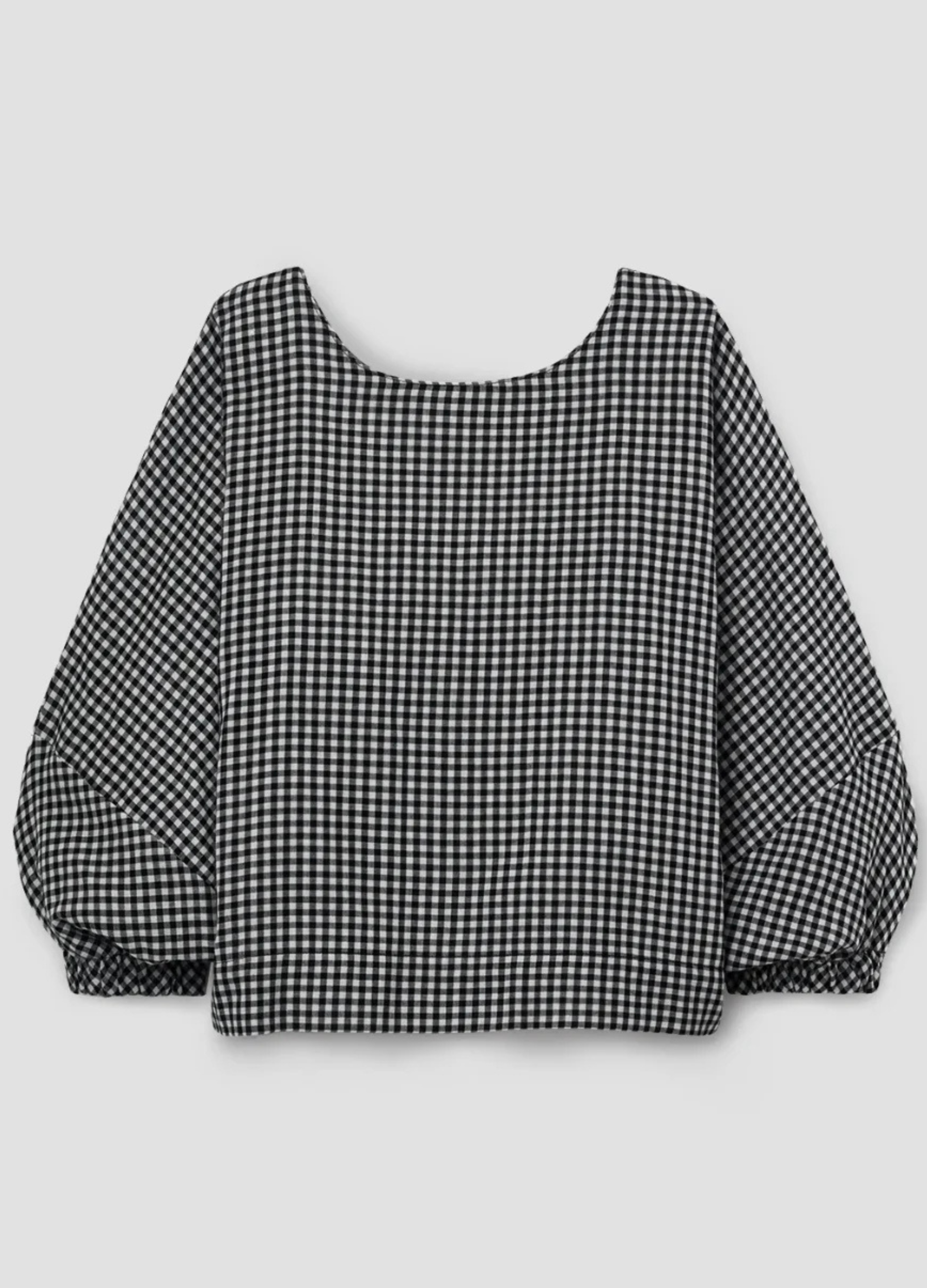 Black and white checkered blouse with balloon sleeves on a light gray background