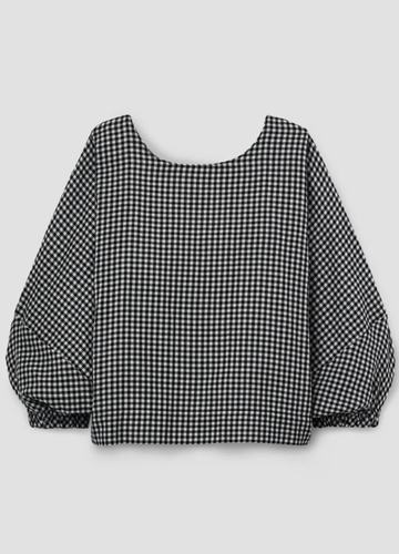 Black and white checkered blouse with balloon sleeves on a light gray background