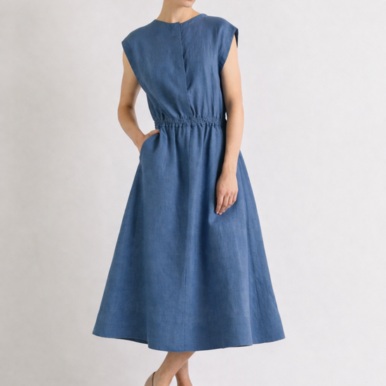 Woman wearing a blue linen dress on a white background from Mei MeiJ