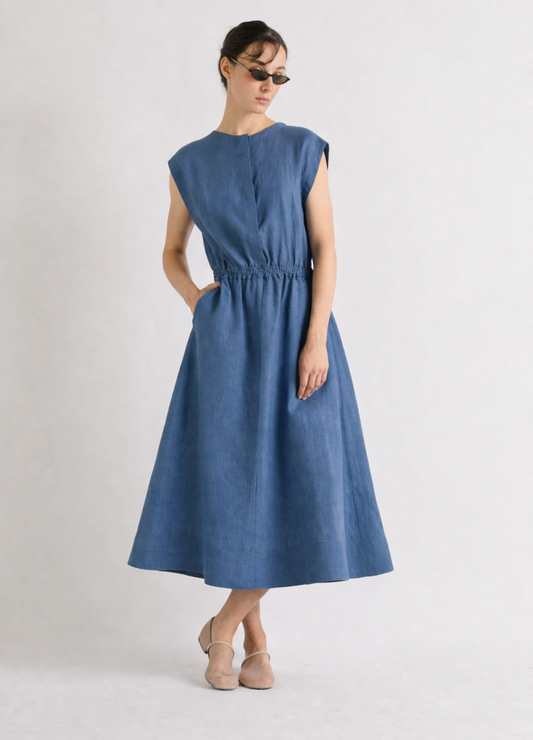 Woman wearing a blue linen dress on a white background from Mei MeiJ