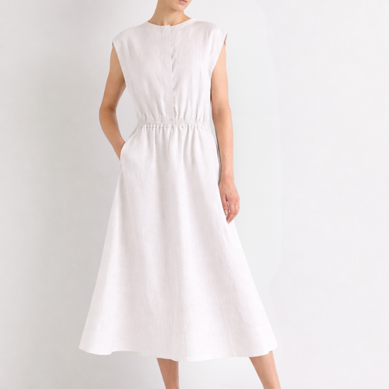 Woman wearing a white linen dress on a plain background from Mei meiJ
