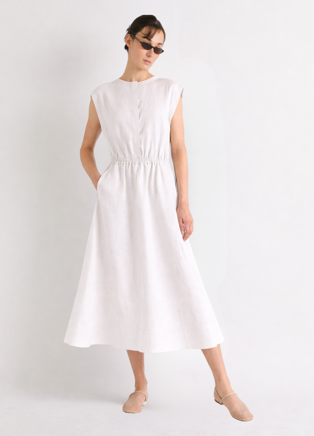 Woman wearing a white linen dress on a plain background from Mei meiJ