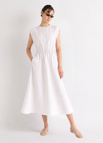 Woman wearing a white linen dress on a plain background from Mei meiJ