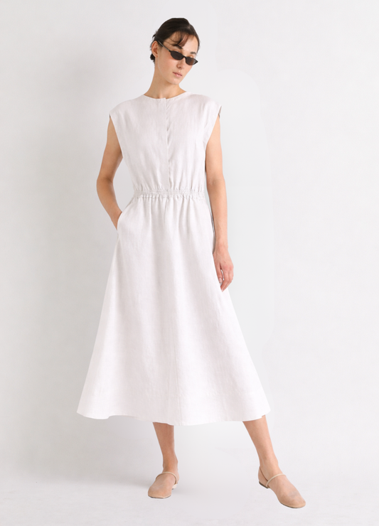 Woman wearing a white linen dress on a plain background from Mei meiJ