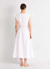 Woman wearing a white linen dress against a plain background from Mei meiJ