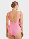Woman wearing a pink swimsuit on a white background