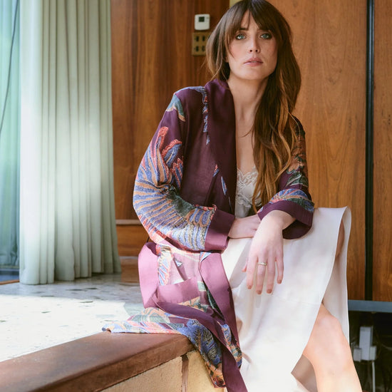 Navy blue dressing gown with colourful parsley seed plants all over from one hundred stars model shot