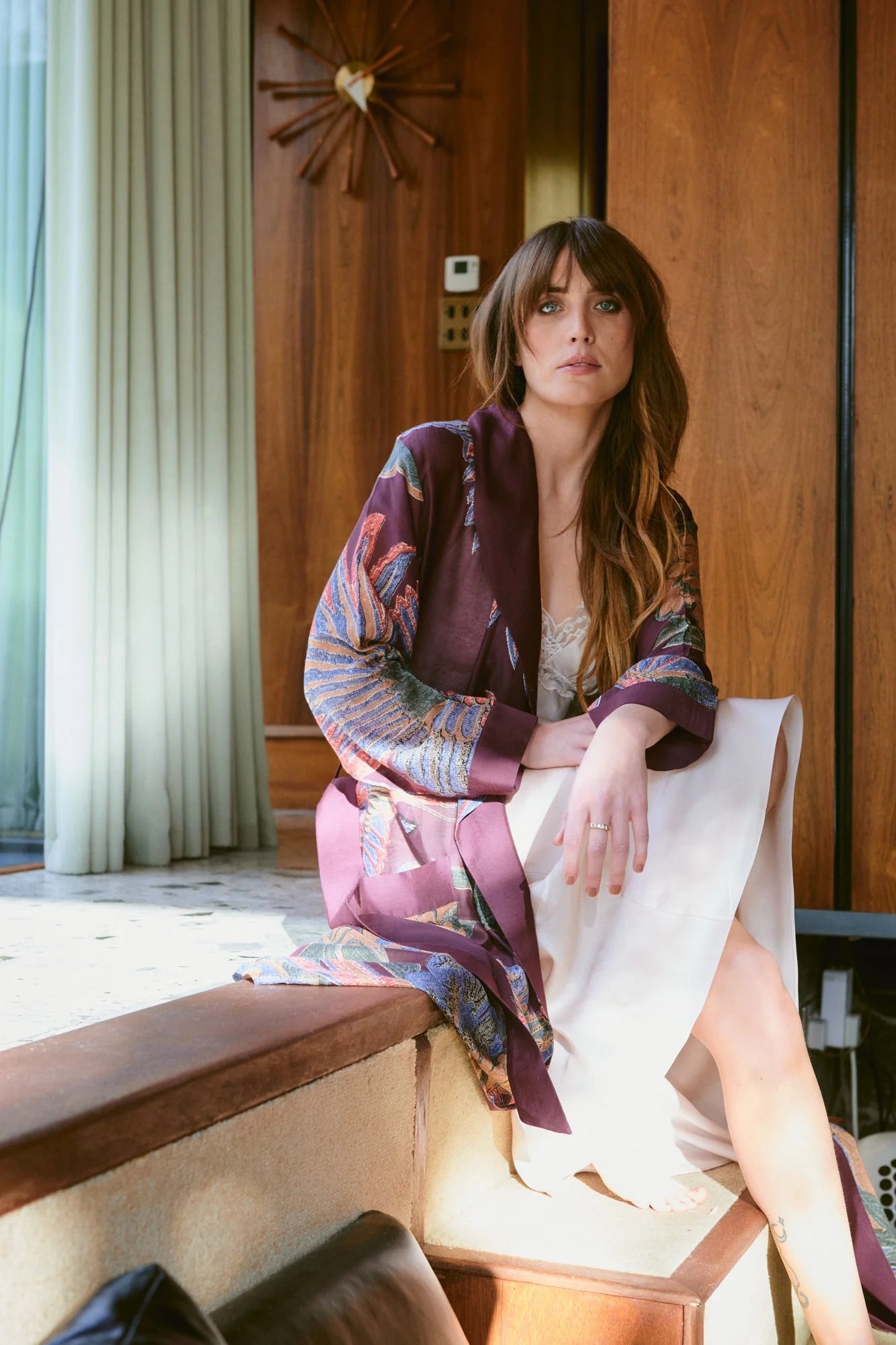 Navy blue dressing gown with colourful parsley seed plants all over from one hundred stars model shot