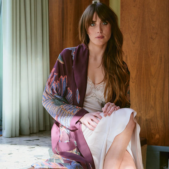 Navy blue dressing gown with colourful parsley seed plants all over from one hundred stars model shot