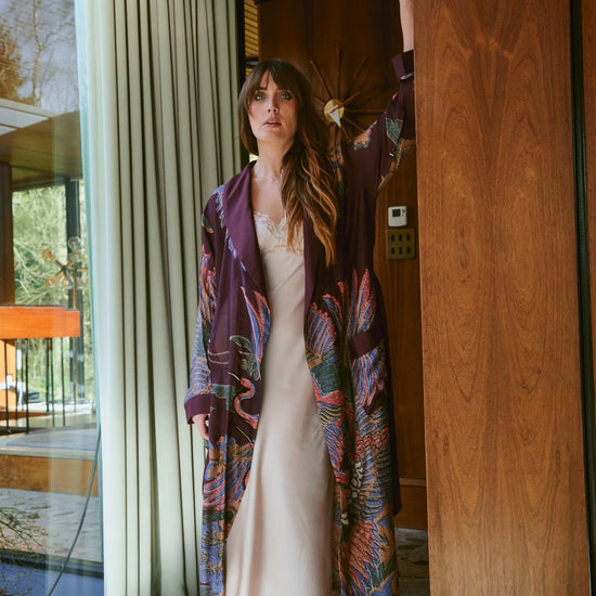 Navy blue dressing gown with colourful parsley seed plants all over from one hundred stars model shot